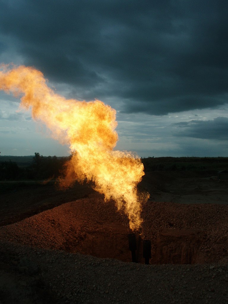 Oil producers flaring natural gas at a drilling site in the USA.