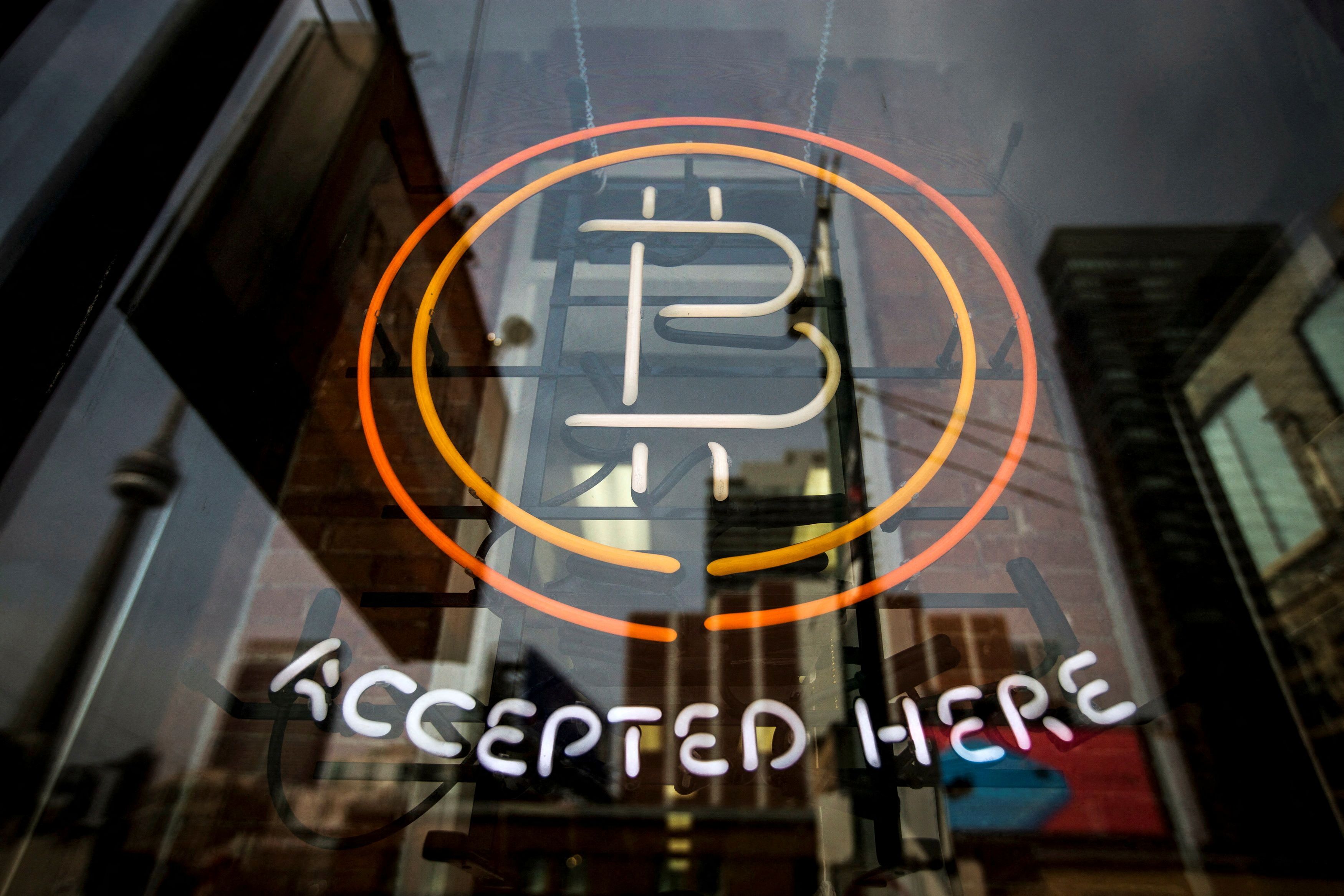 A Bitcoin sign is seen in a window in Toronto